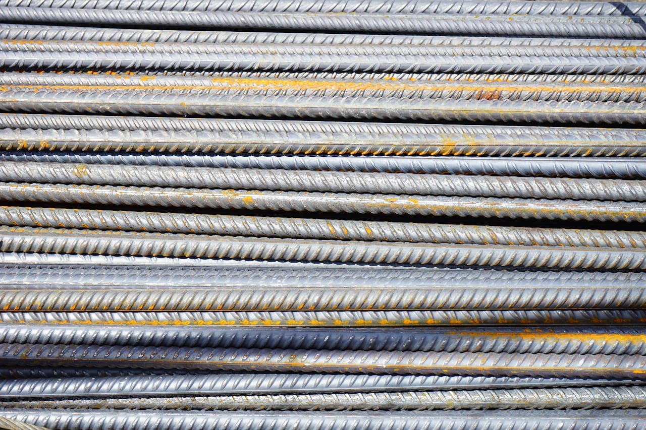 about-07 Close-up of stacked rusty steel reinforcing bars used in construction.